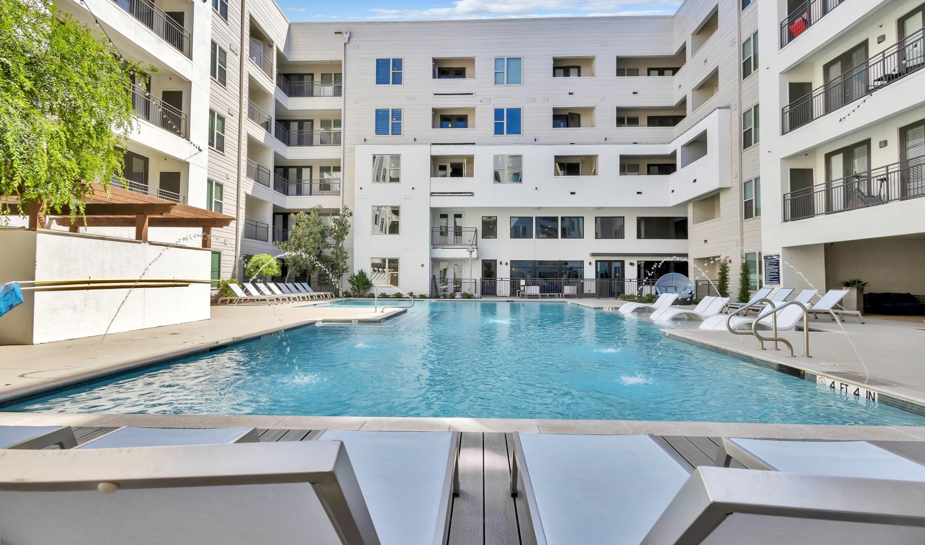 Resort-style swimming pool with lounge seating