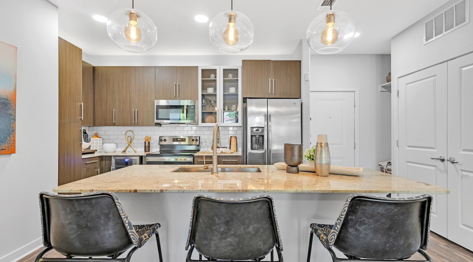 a kitchen with an island and chairs