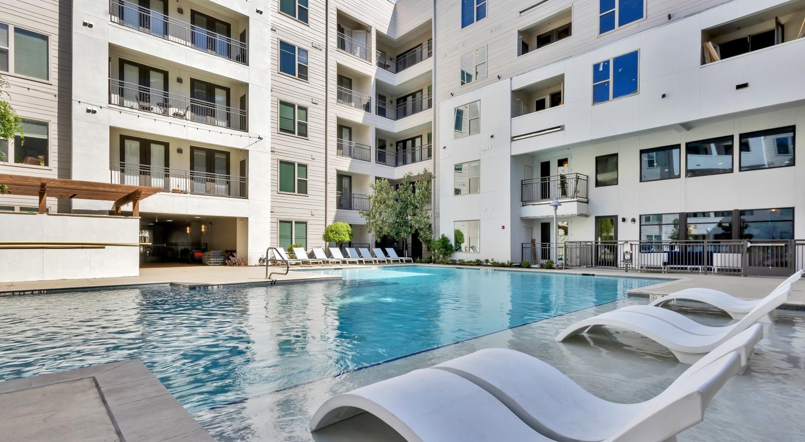 Resort-style swimming pool with lounge seating