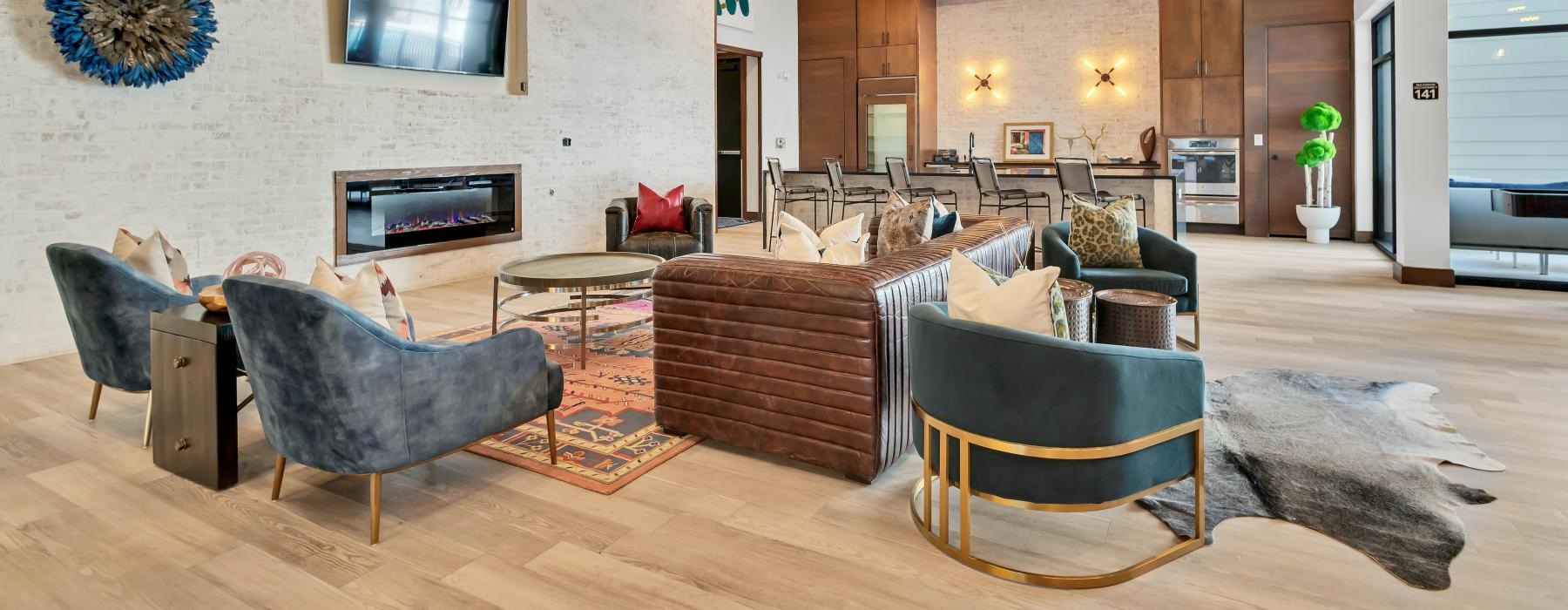 a spacious clubroom with a wood floor and a tv and a fireplace