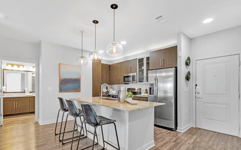 a kitchen with a bar and chairs